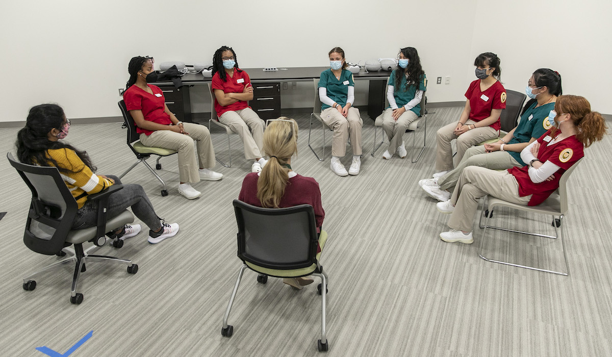 students sit in a circle