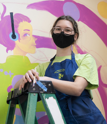 woman on a ladder with mask