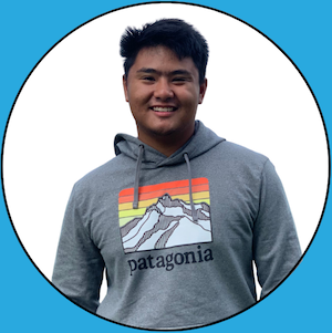 A headshot of Jared Ponmakha, who is smiling at the camera, wearing a grey Patagonia sweatshirt.