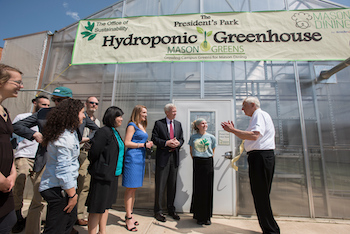 people standing outside greenhouse