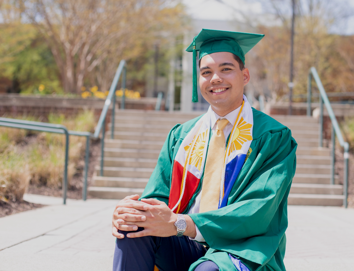 guy in cap and gown outside