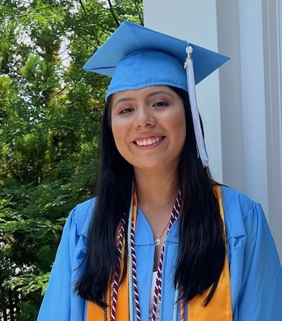 woman in a cap and gown on a deck