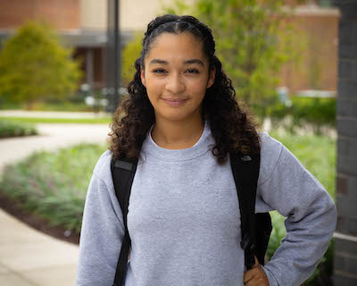 young woman posing outside