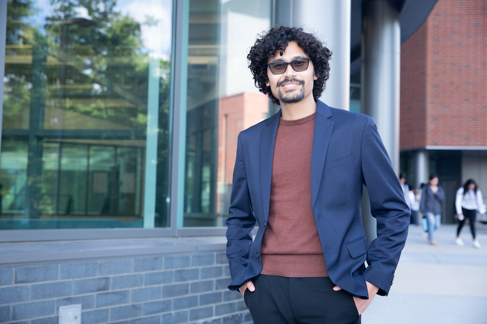 man with sunglasses outside Horizon Hall