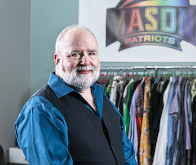 Ric Chollar in front of clothing and a Patriots sign