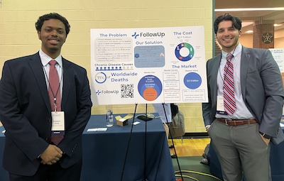 Mason student and his poster at the CGI U conference