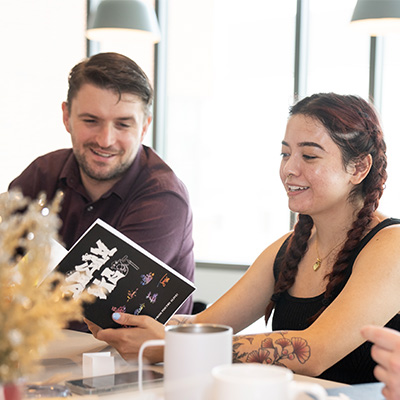 Martin Mitchell and Victoria Mendoza making chapbooks for the students at the JDC. Photo by Evan Cantrell/OUB.