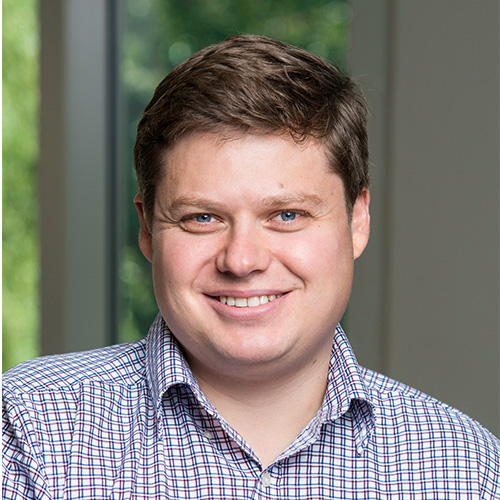 Mason associate professor Vadim Sokolov wears a blue striped shirt