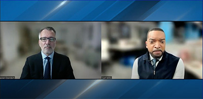 Dean Ozerdem appears on television beside interviewer Carl Willis