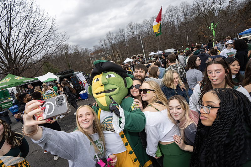 Students gather with the Patriot at the Homecoming Tailgate