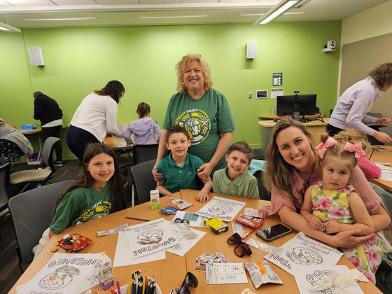 Mason staff member and her kids do crafts at the library on campus