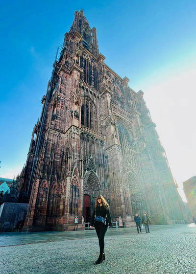 A student poses in front of the Strasbourg Cathedral in France.